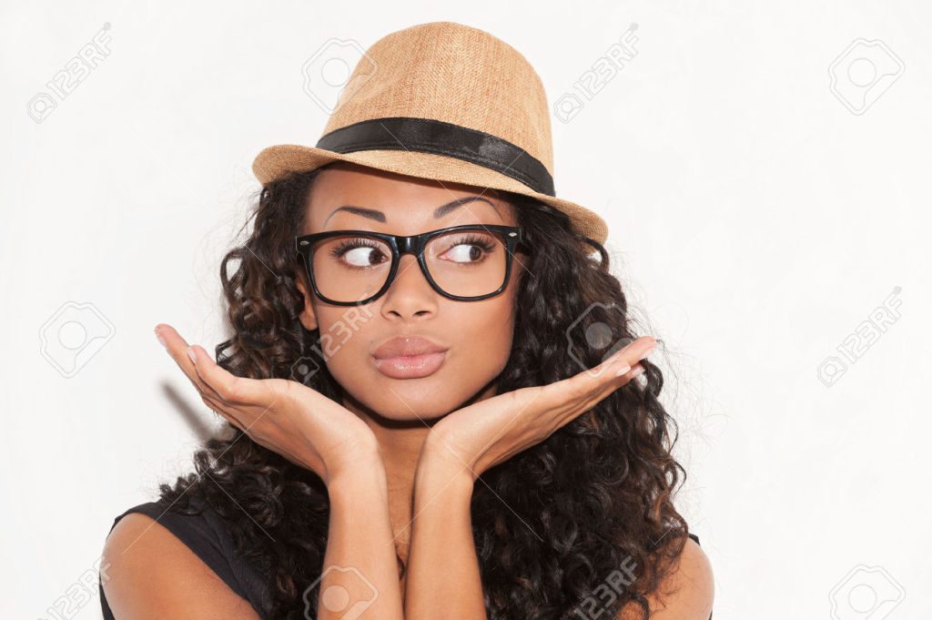 26897849-Stylish-beauty-Portrait-of-beautiful-young-African-woman-in-glasses-and-funky-hat-gesturing-and-look-Stock-Photo