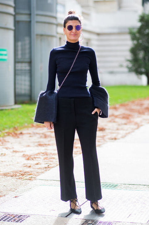 bell-sleeve-top-outfit-ideas-ribbed-top-trousers-flats-getty-images-h724