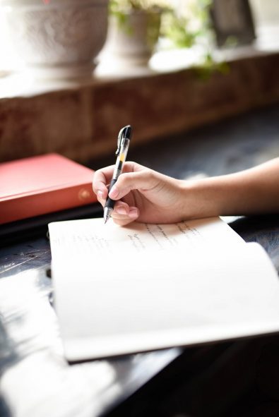 photo of a woman writing her wedding plan and budget