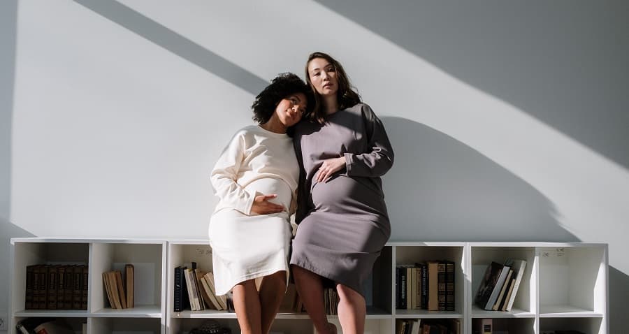 Photo of two pregnant women posing for a photograph - Fashion Police Nigeria