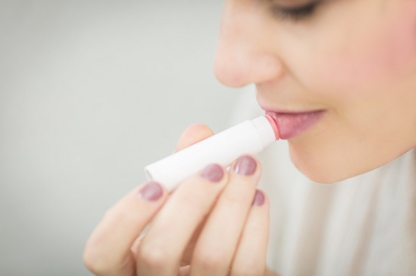 Woman Applying Lipstick