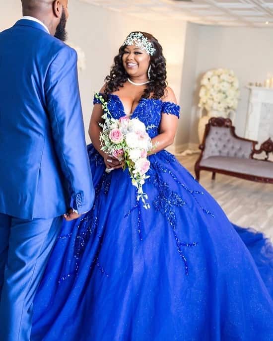 Bride and groom in unconventional blue wedding dress - photo
