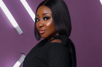 Ini Edo Wearing A Turtleneck Top and Thigh-High Booties