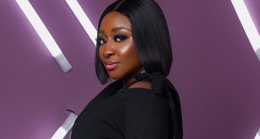 Ini Edo Wearing A Turtleneck Top and Thigh-High Booties