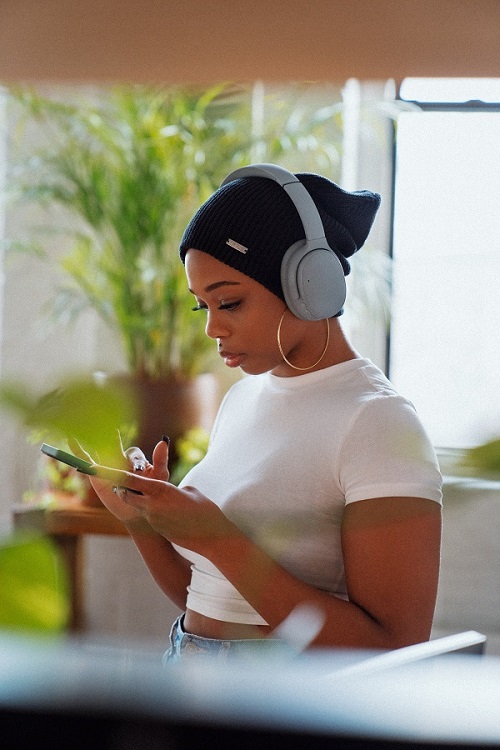 Photo of African American Woman Wearing Black Beanie With White T-Shirt