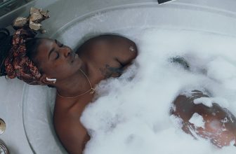 Photo of black American American Woman in Bath Tub For Self Care