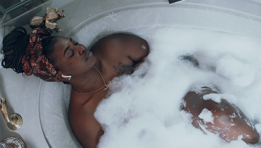 Photo of black American American Woman in Bath Tub For Self Care