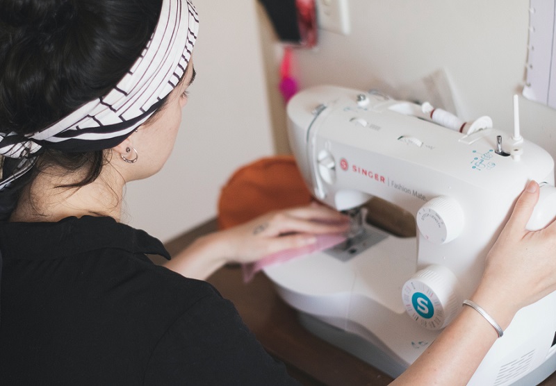 fashion designer sewing a dress