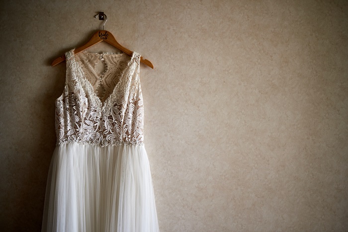 Photo pf Vintage wedding dress hanging in a room