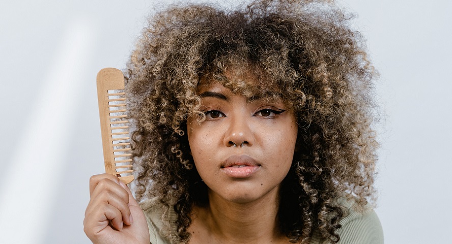 Photo of woman with curly hair and comb