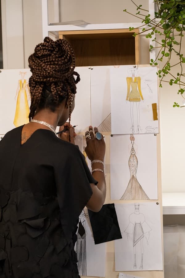 Photo of a woman fashion designer illustrating 