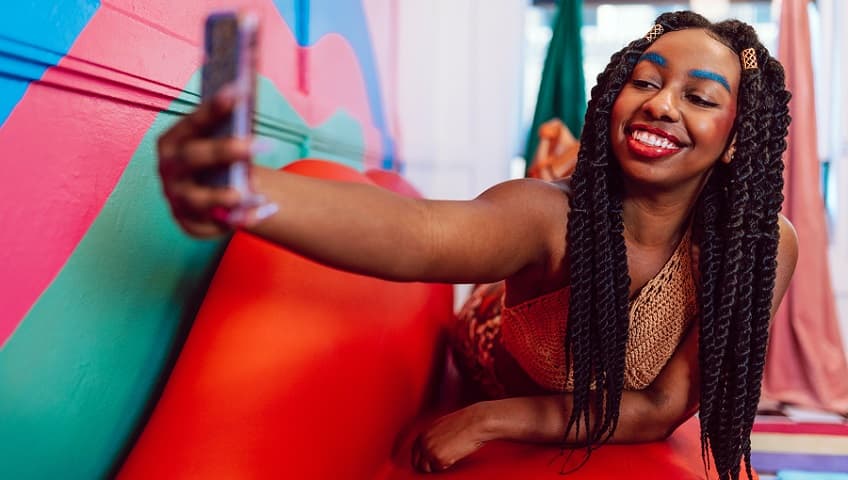 African American Woman Makeup Look Taking Selfie