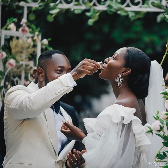 Photo of bride receiving communion from the groom