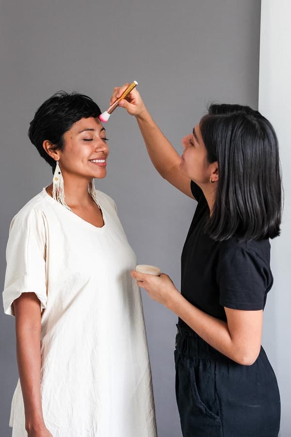 Woman applying makeup photo