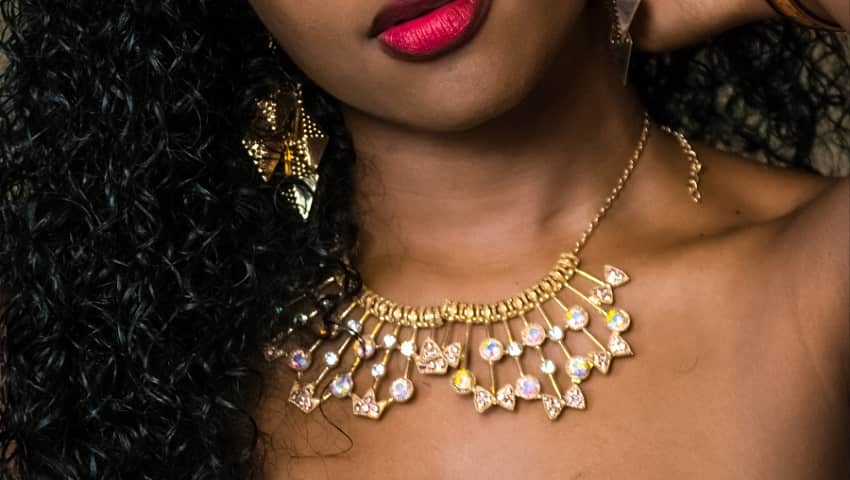 African American wearing layered necklace image