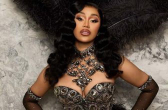 Cardi B Shimmers in a Regal Corset Top and Dramatic Feathery Headpiece