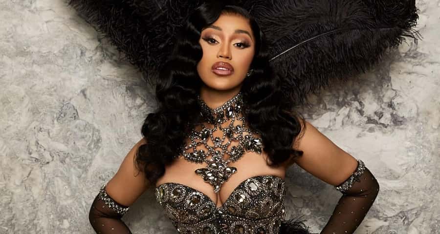 Cardi B Shimmers in a Regal Corset Top and Dramatic Feathery Headpiece
