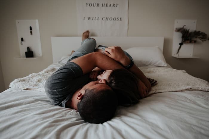 Couple laying in bed together image