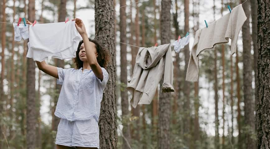 Photo of African American Drying Clothes in the woods after laundry