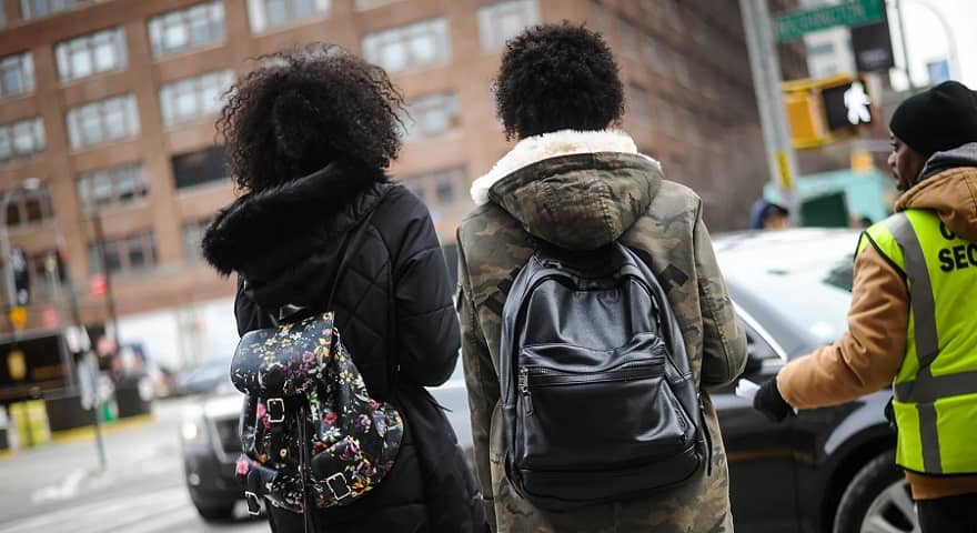 Women street style photo wearing backpacks