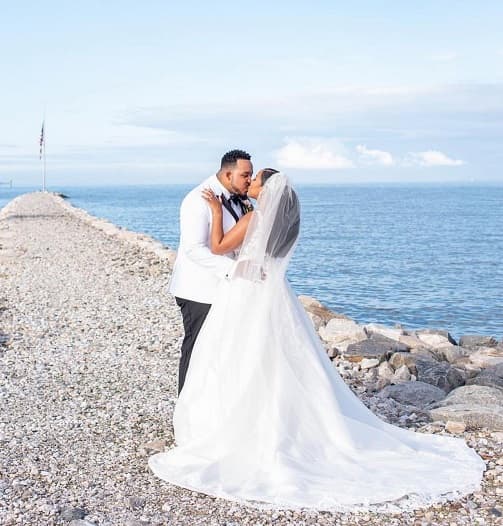 Couple kissing by the sea destination wedding photo - Fashion Police Nigeria
