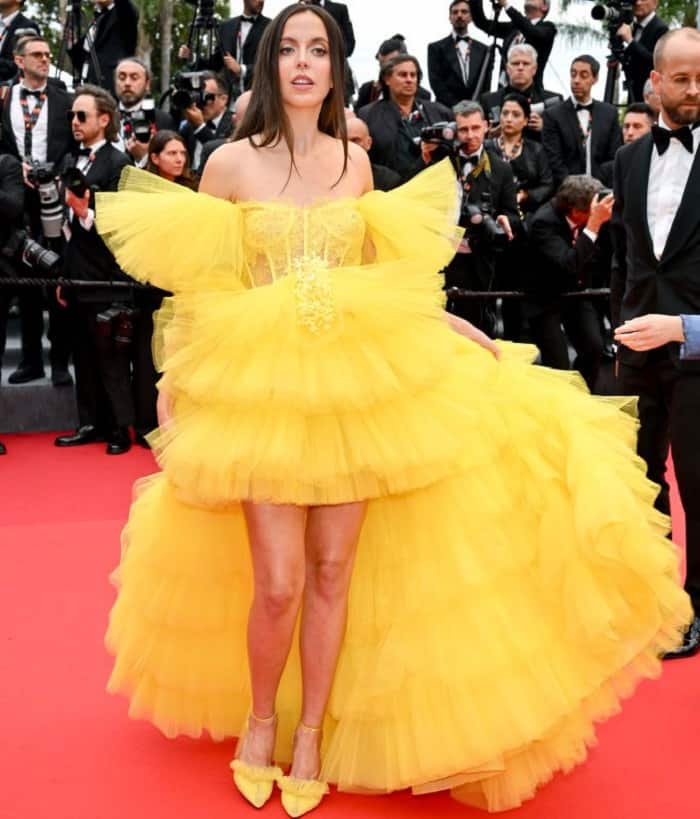 Marta Sierra in a bright yellow tulle hi-low gown