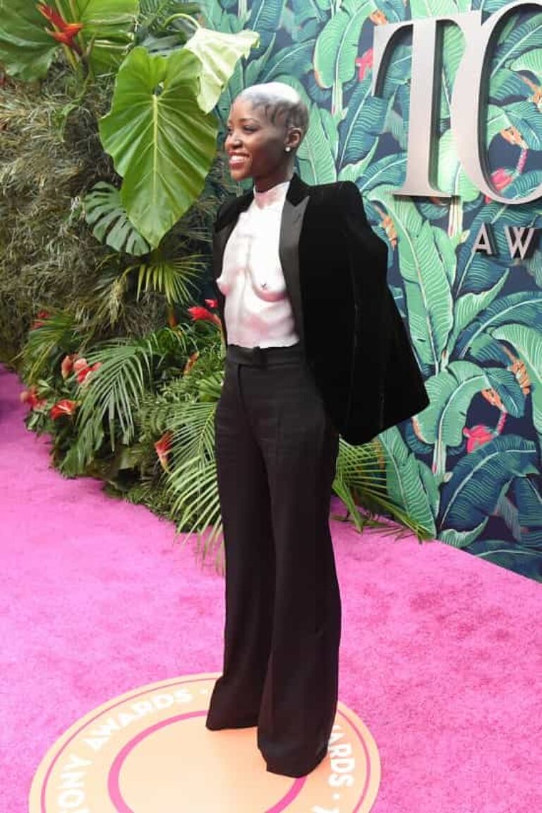 Lupita Nyong'o Wears A Black Velvet Suit With Silver Breastplate At The ...