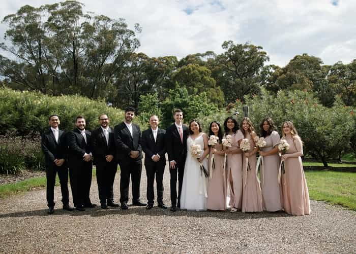 Photo of groomsmen and bridesmaids standing for a photoshoot