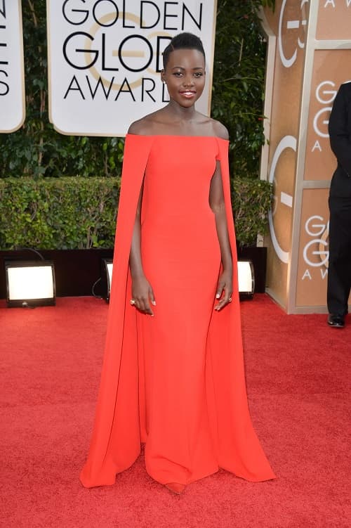 Photo of Lupita Nyong’o wearing the red Ralph Lauren cape dress at the Golden Globes in 2014 - Fashion Police Nigeria
