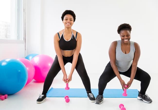 photo of two women working out with weights - Fashion Police Nigeria