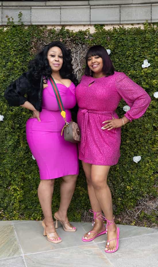 Two plus-size women pose beautifully for the camera in pink empire waist dresses - Fashion Police Nigeria