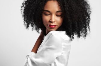 Young black woman with curly hair watching down