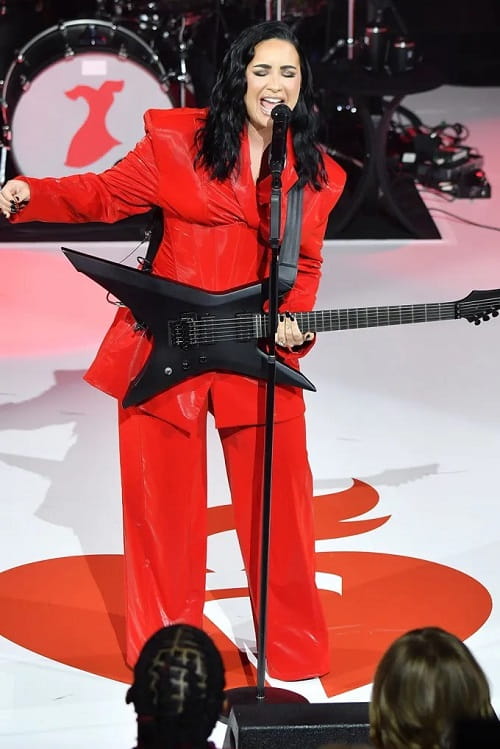 Photo of demi lovato performing at aha concert in a red attire
