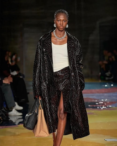 image of woman in leather coat on runway