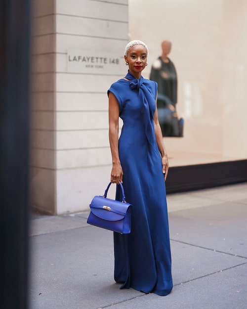 image of African American woman wearing a sleeveless blue dress- Fashion Police Nigeria