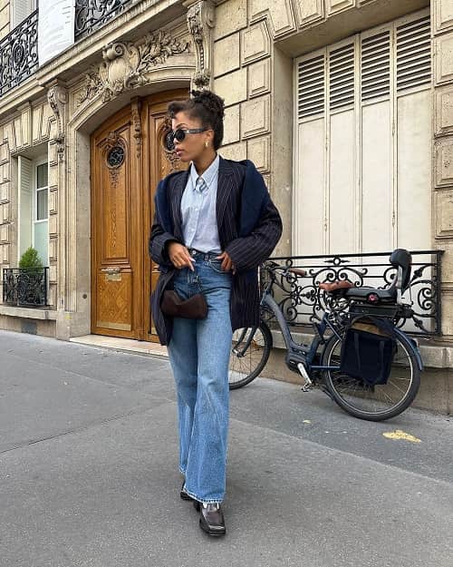 Photo of African American woman wearing a black blazer and blue jean- Fashion Police NIgeria