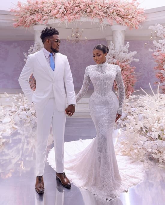 Photo of Veekee James wedding ceremony as wore a stunning, corseted and modest lace wedding gown with long sleeves and high neck - Fashion Police Nigeria