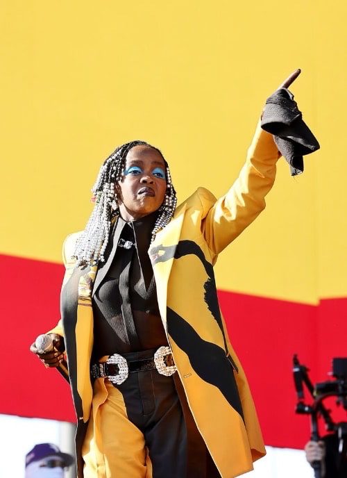 Lauryn Hill in a Sleek Black and Yellow Outfit From Balmain Fall '24 ready-to-wear collection - Fashion Police Nigeria