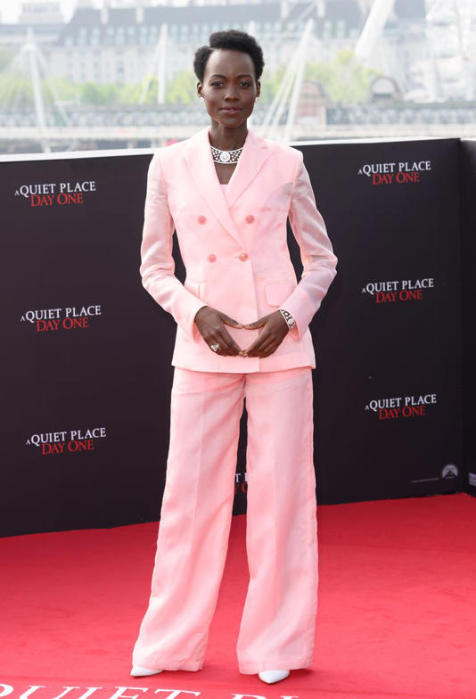 Lupita Nyong'o arrived the red carpet in a pink pantsuit along with her cat during 