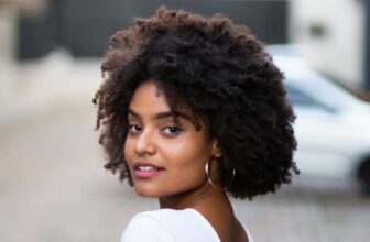 Photo of a woman wearing white t-shirt and curly natural hair - Fashion Police Nigeria