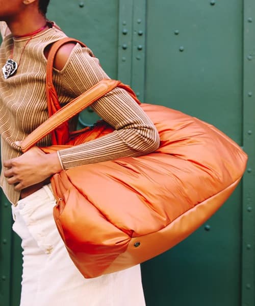 A model carrying a large weekender bag photo - Fashion Police Nigeria