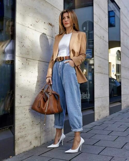 Photo of a woman wearing the mom's jeans with a blazer