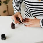 Woman painting her nails photo - Fashion Police Nigeria