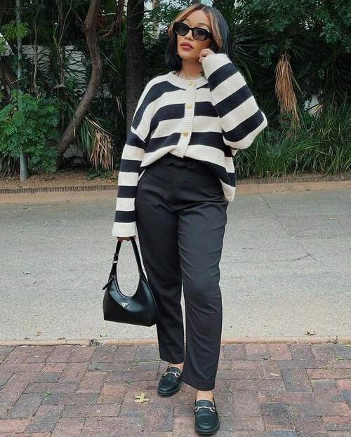 African American woman wearing a vintage long-sleeve blouse with tailored pants trouser