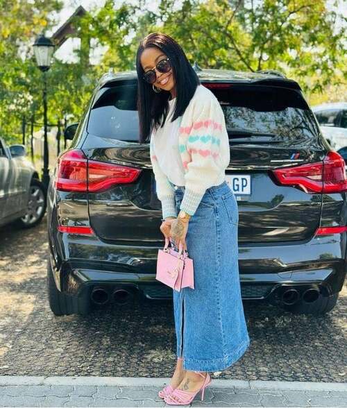 A beautiful fashion woman wedding a vintage French fashion in cardigan with a long denim skirt and pink bag and shoes