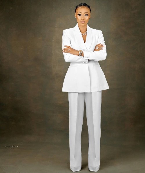 Photo of a woman on a white suit - Fashion Police Nigeria