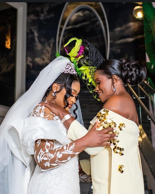 A beautiful photo of the bride and her mother praying together on her wedding day