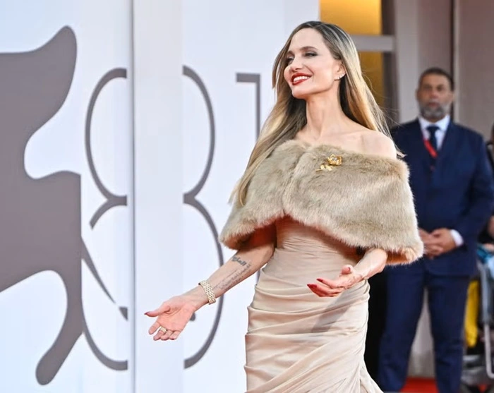 Photo of Angelina Jolie exuding pure elegance in a draped gown and fur wrap at Venice Film Festival 2024 - Fashion Police Nigeria