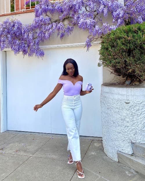 Photo of a woman on a cutout high waisted Jean and a pink off-the-shoulder top- Fashion Police Nigeria