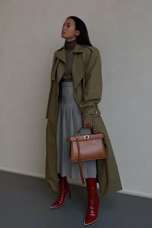 Fashion woman wearing tailored coat with thigh-high boots 